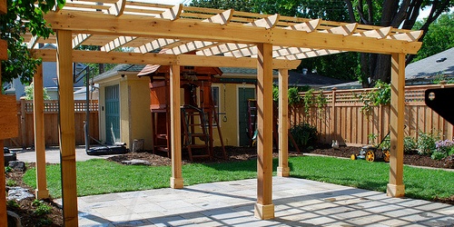 adding a pergola is one hardscape idea for a large backyard makeover