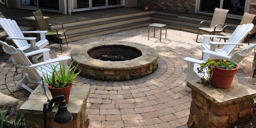 adding a fire pit is one hardscape idea for a large backyard makeover